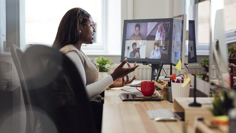 A side view of a manager speaking to her staff who are working from home. She is having a team briefing and getting up to date with everyones progress. She is working in her office in Newcastle Upon Tyne in the North East of England.